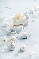 Image showing Christmas ornaments, balls and small present box on sledge