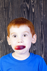 Image showing red-haired boy eats