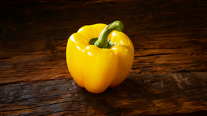 Image showing Fresh yellow sweet peper onwooden background.