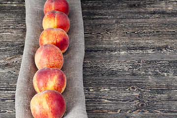 Image showing row ripe orange peaches