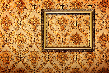Image showing Vintage gold plated picture frame on retro wallpaper