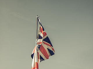 Image showing Vintage looking Flag of UK over blue sky