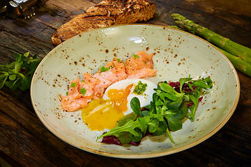 Image showing Slow Cooked Salmon fillet steak with salad on plate, Sous-Vide Cooking Salmon Fish