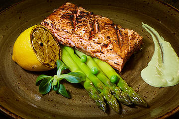 Image showing Slow Cooked Salmon fillet steak with salad on plate, Sous-Vide Cooking Salmon Fish