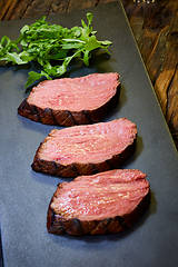 Image showing Sous-vide steak cut into pieces, cooked to eat beef on the stone table