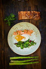 Image showing Slow Cooked Salmon fillet steak with salad on plate, Sous-Vide Cooking Salmon Fish