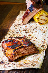 Image showing Roasted sliced barbecue pork ribs, focus on sliced meat