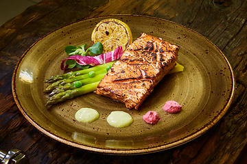 Image showing Slow Cooked Salmon fillet steak with salad on plate, Sous-Vide Cooking Salmon Fish