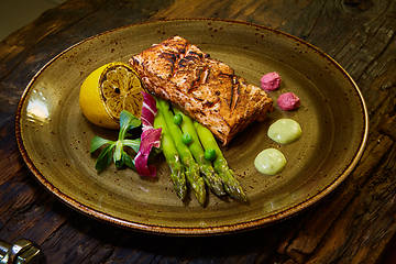 Image showing Slow Cooked Salmon fillet steak with salad on plate, Sous-Vide Cooking Salmon Fish