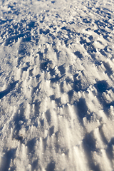 Image showing snow-covered soil surface close up ,