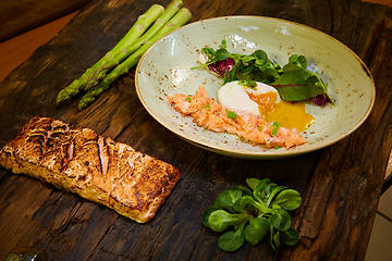 Image showing Slow Cooked Salmon fillet steak with salad on plate, Sous-Vide Cooking Salmon Fish