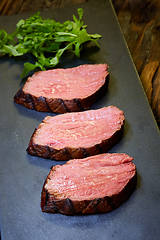 Image showing Sous-vide steak cut into pieces, cooked to eat beef on the stone table