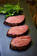 Image showing Sous-vide steak cut into pieces, cooked to eat beef on the stone table