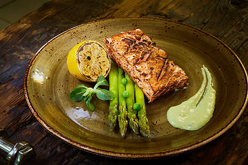 Image showing Slow Cooked Salmon fillet steak with salad on plate, Sous-Vide Cooking Salmon Fish