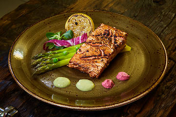 Image showing Slow Cooked Salmon fillet steak with salad on plate, Sous-Vide Cooking Salmon Fish