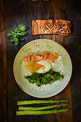 Image showing Slow Cooked Salmon fillet steak with salad on plate, Sous-Vide Cooking Salmon Fish