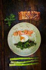 Image showing Slow Cooked Salmon fillet steak with salad on plate, Sous-Vide Cooking Salmon Fish