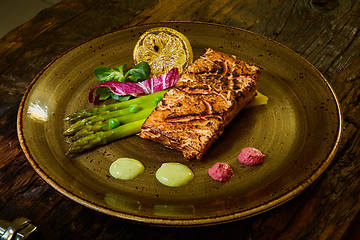 Image showing Slow Cooked Salmon fillet steak with salad on plate, Sous-Vide Cooking Salmon Fish