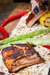 Image showing Roasted sliced barbecue pork ribs, focus on sliced meat