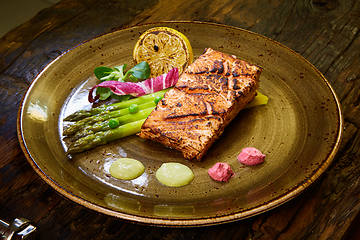 Image showing Slow Cooked Salmon fillet steak with salad on plate, Sous-Vide Cooking Salmon Fish