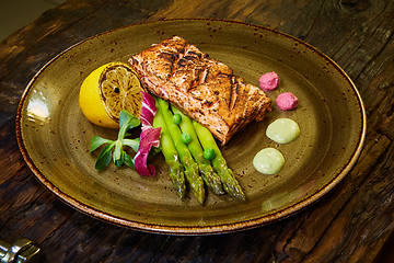 Image showing Slow Cooked Salmon fillet steak with salad on plate, Sous-Vide Cooking Salmon Fish