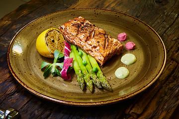 Image showing Slow Cooked Salmon fillet steak with salad on plate, Sous-Vide Cooking Salmon Fish