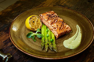 Image showing Slow Cooked Salmon fillet steak with salad on plate, Sous-Vide Cooking Salmon Fish