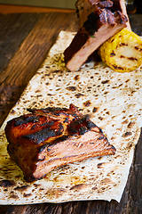 Image showing Roasted sliced barbecue pork ribs, focus on sliced meat