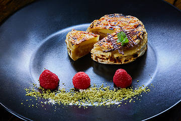 Image showing Slice of vanilla cheesecake decorated with apple topping