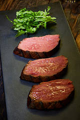 Image showing Sous-vide steak cut into pieces, cooked to eat beef on the stone table