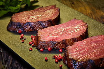 Image showing Sous-vide steak cut into pieces, cooked to eat beef on the stone table