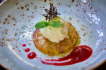 Image showing Grilled pineapple with scoops of vanilla ice cream