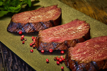 Image showing Sous-vide steak cut into pieces, cooked to eat beef on the stone table