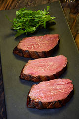 Image showing Sous-vide steak cut into pieces, cooked to eat beef on the stone table