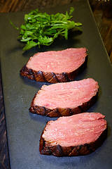 Image showing Sous-vide steak cut into pieces, cooked to eat beef on the stone table