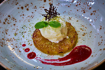 Image showing Grilled pineapple with scoops of vanilla ice cream