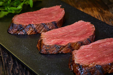 Image showing Sous-vide steak cut into pieces, cooked to eat beef on the stone table