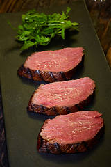 Image showing Sous-vide steak cut into pieces, cooked to eat beef on the stone table