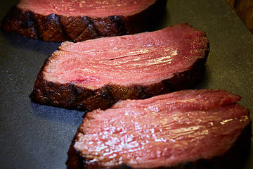 Image showing Sous-vide steak cut into pieces, cooked to eat beef on the stone table