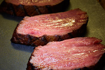 Image showing Sous-vide steak cut into pieces, cooked to eat beef on the stone table