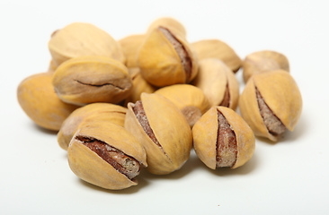 Image showing Heap of organic salted pistachio nuts on white background