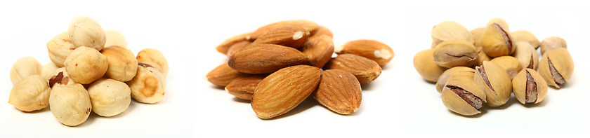 Image showing A set of three kinds of nuts. Three heaps of nuts, pistachios, almonds and hazelnuts.