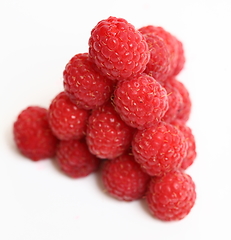 Image showing The pyramid of ripe raspberry over white background