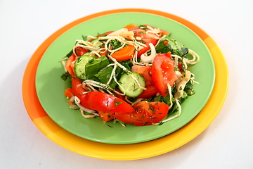 Image showing The salad with cucumbers, tomatoes and herbs