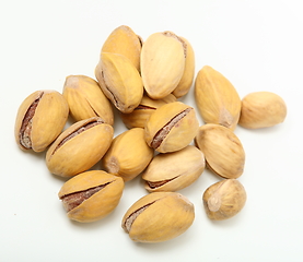 Image showing Heap of organic salted pistachio nuts on white background