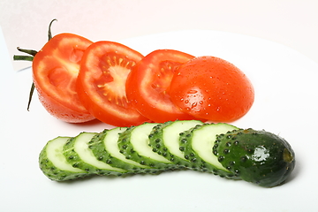 Image showing sliced tomato and cucumber on white background
