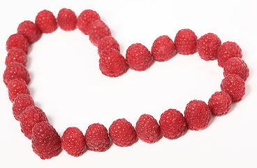 Image showing Heart made out of raspberries over white background