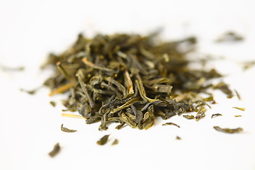 Image showing Pile of green tea on white background. Shallow dof