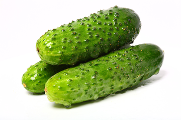 Image showing Three fresh organic cucumbers on white background