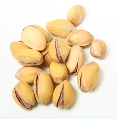 Image showing Heap of organic salted pistachio nuts on white background